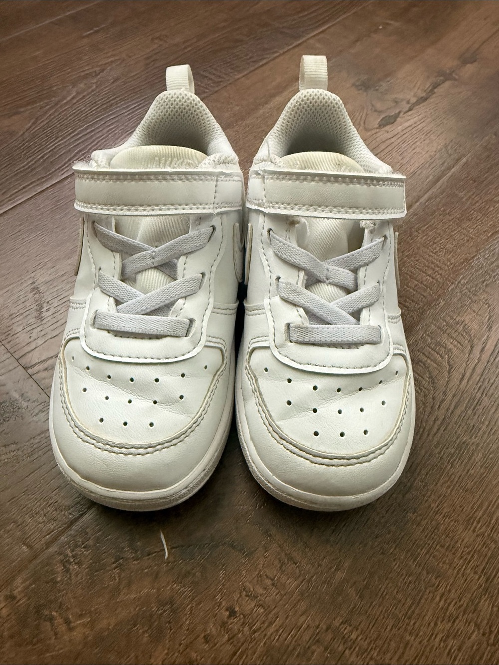 Kids white Nike tennis shoes